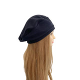 Navy blue beanie on a mannequin head with long blonde hair against a white background