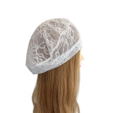 White lace headband on a mannequin head with long blonde hair against a white background
