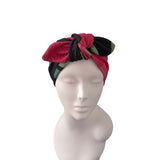 A multicolor fabric headwrap styled on a white mannequin head against a plain white background.