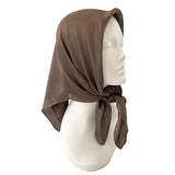 Brown headscarf on a mannequin head against a white background