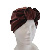 Brown headband on a mannequin head against a white background