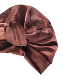 Brown velvet turban on a white background