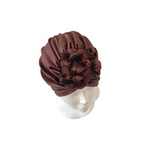 Brown turban on a mannequin head against a white background