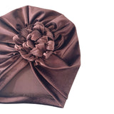 Brown headscarf with a flower accessory on a white background