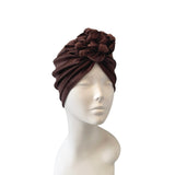 Brown headscarf on a mannequin head against a white background