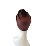 Brown headscarf on a white mannequin head against a white background