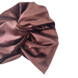 Brown fabric bow on a white background