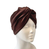 Brown turban on a mannequin head against a white background
