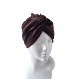 Brown headscarf on a mannequin head against a white background