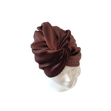 Brown headscarf on a mannequin head against a white background