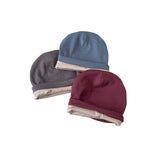 Three hats in gray, blue, and burgundy on a white background