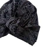 Black patterned headscarf on a white background
