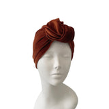 Brown turban on a mannequin head against a white background