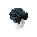Blue knit headband with a bow on a white background