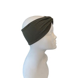 Dark green headband on a mannequin head against a white background