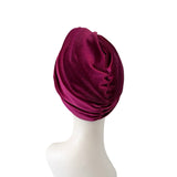 Maroon headscarf on a mannequin head against a white background