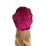 Purple headscarf on a mannequin head with blonde hair against a white background