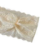 Cream-colored lace fabric with a bow on a white background