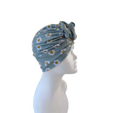 Turban with floral pattern on a mannequin head against a white background