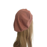 Brown beanie on a mannequin head with long blonde hair against a white background