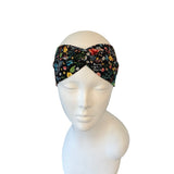 Floral patterned headband on a mannequin head against a white background