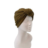Brown turban on a mannequin head against a white background