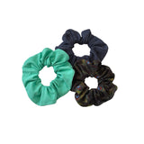 Three scrunchies in green, black, and patterned black on a white background