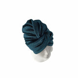Blue textured turban on a mannequin head against a white background