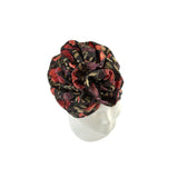 Floral patterned headscarf on a mannequin head against a white background