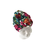 Colorful floral headscarf on a mannequin head against a white background