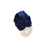 Navy blue velvet turban on a mannequin head against a white background