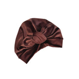 Brown satin headband with a bow on a white background