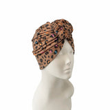 Leopard print headscarf on a mannequin head against a white background