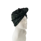 Black and gray striped headscarf on a mannequin head against a white background