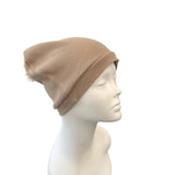 Beige beanie on a mannequin head against a white background