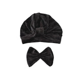 Black velvet turban and headband set on a white background