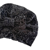 Black patterned headscarf with a bow on a white background