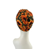 Sunflower patterned headscarf on a mannequin head against a white background