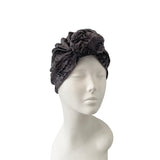 Gray turban on a mannequin head against a white background