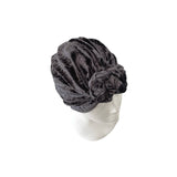 Gray velour turban on a mannequin head against a white background
