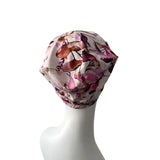 Floral-patterned headscarf on a mannequin head against a white background
