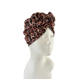 Leopard print headscarf on a mannequin head against a white background