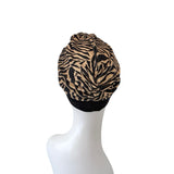 Zebra print headscarf on a mannequin head against a white background