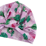 Tropical patterned headscarf with pink, green, and white colors on a white background
