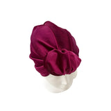 Maroon headscarf on a mannequin head against a white background