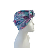 Colorful headscarf on a mannequin head against a white background