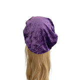 Purple velvet beret on a mannequin head with blonde hair against a white background