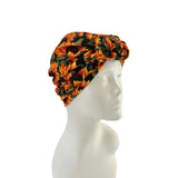 Colorful floral-patterned headscarf on a mannequin head against a white background