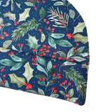 Festive fabric with holly leaves and berries on a blue background