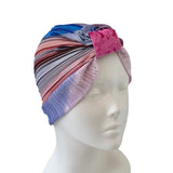 Colorful striped headscarf on a mannequin head against a white background